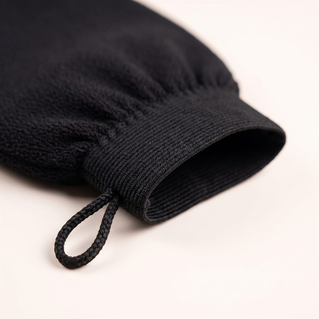 Close-up of the ribbed elastic cuff and hanging loop of the mitt